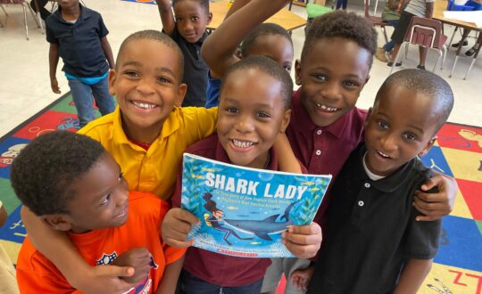 Kids reading about sharks in class