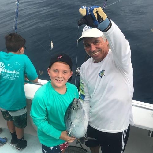 Capt. Rich with a young fisherman student and his catch.