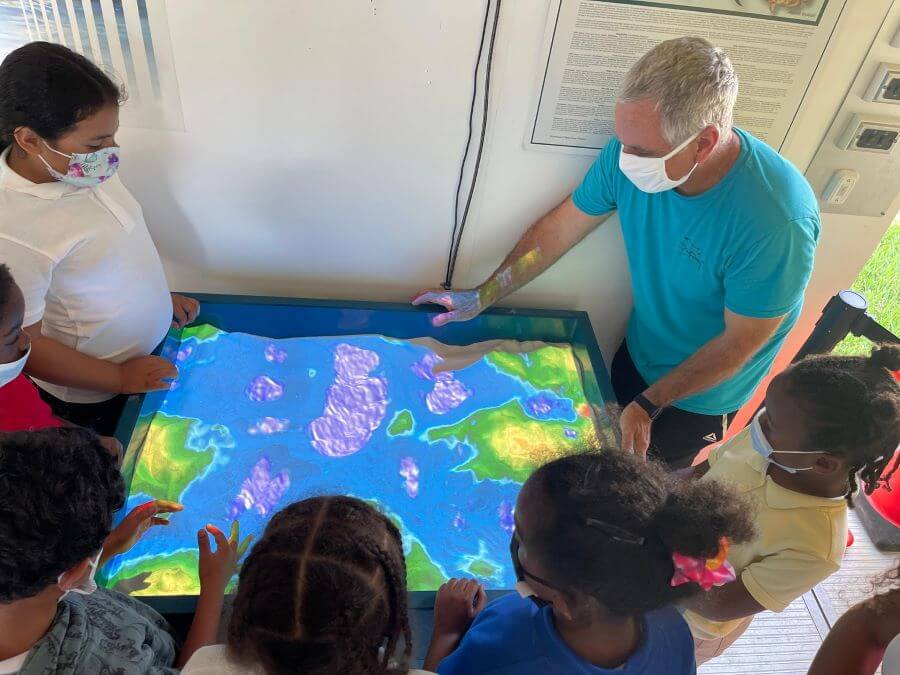 Students use a topography sandbox with augmented reality