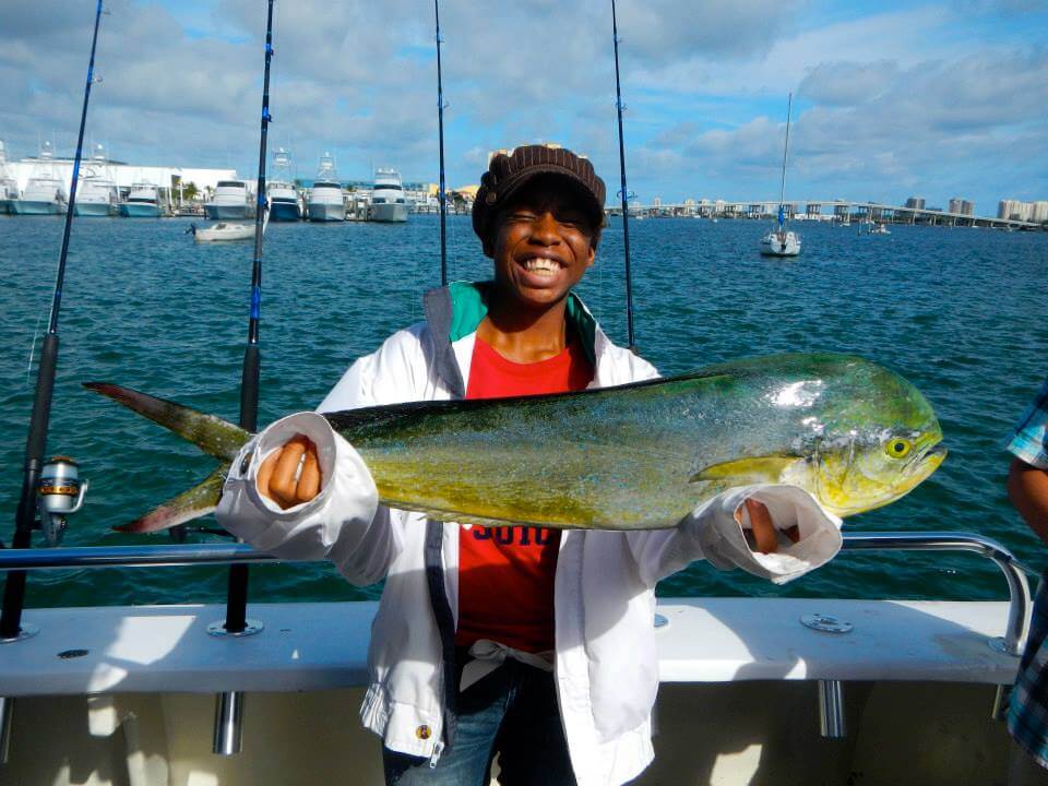 Young girl with dolphin fish she caught fishing with FFA.