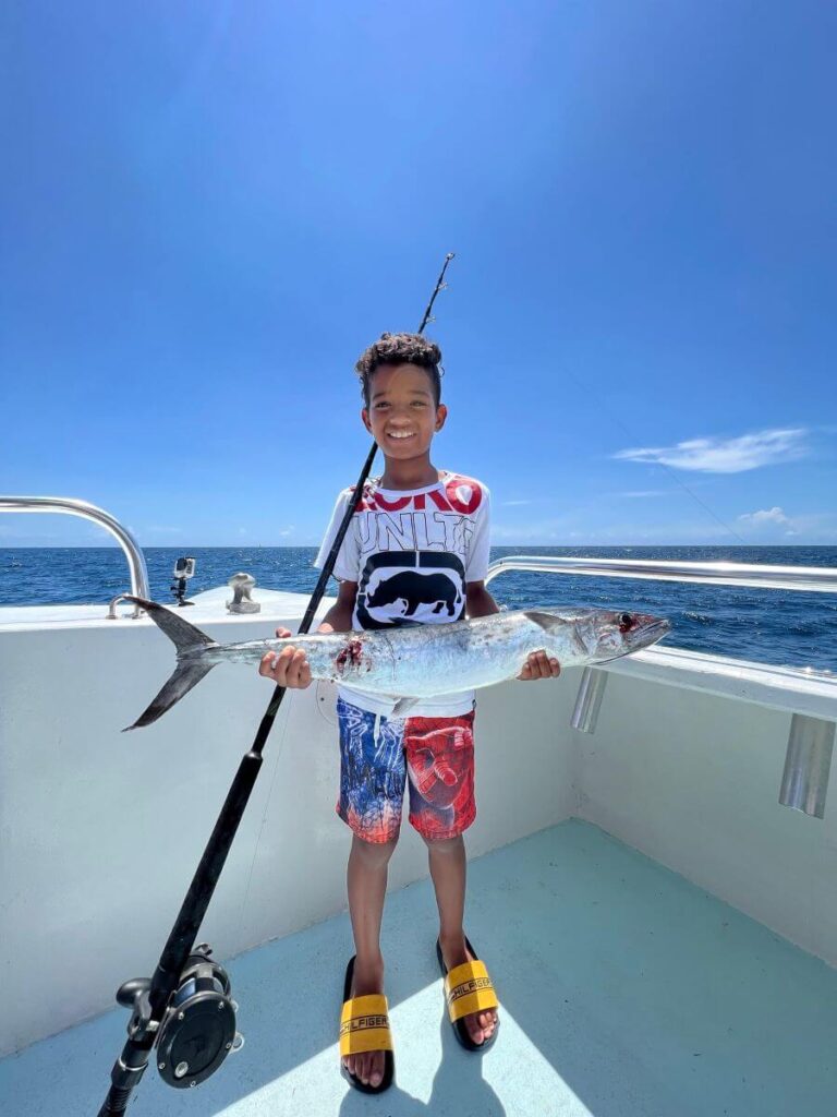 Young elementary student with a large fish catch.
